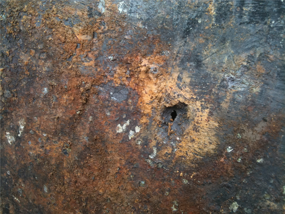 Corrosion hole noted in side of tank. A more serious concern would be if an oil stained area was present on the outside of the tank. Corrosion hole noted in side of tank. A more serious concern would be if an oil stained area was present on the outside of the tank.