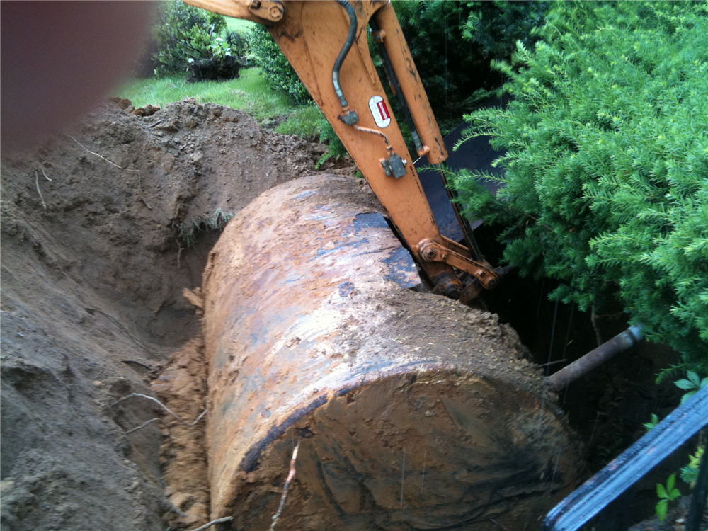 Oil tank being removed from the ground. Oil tank being removed from the ground.