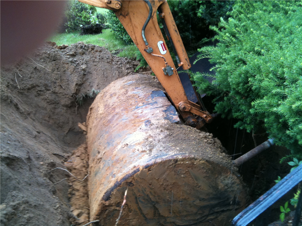 Oil tank being removed from the ground.