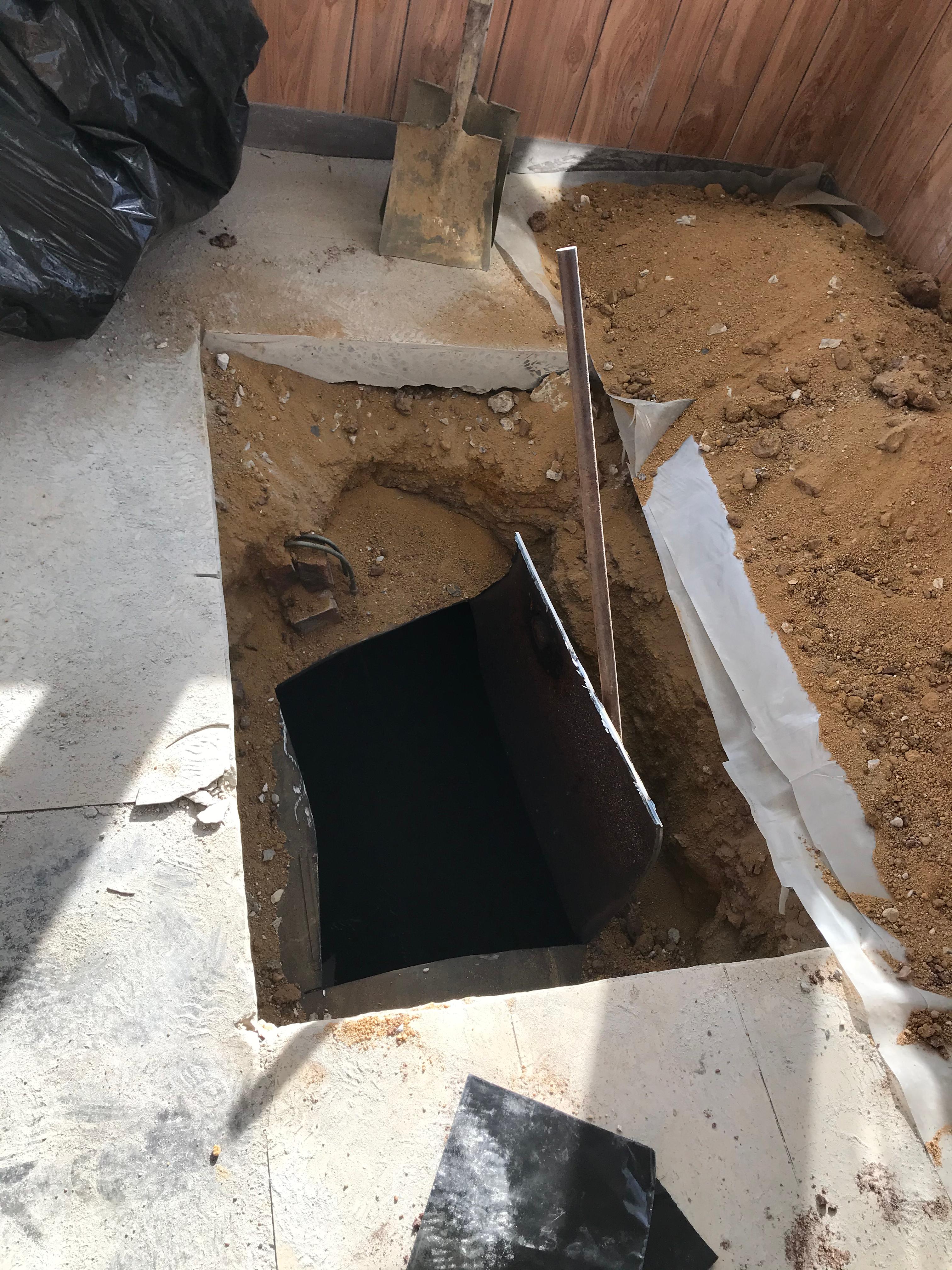 Oil tank buried below a porch
